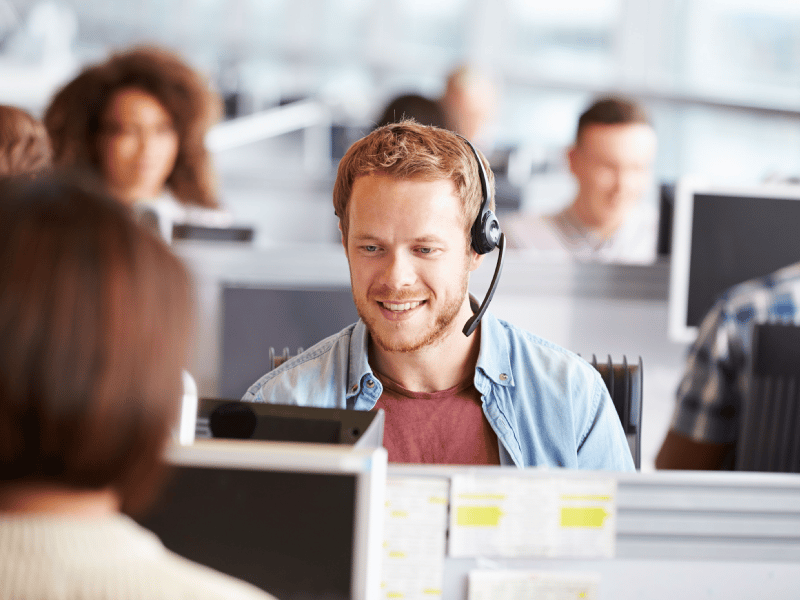 Man smiling in call center