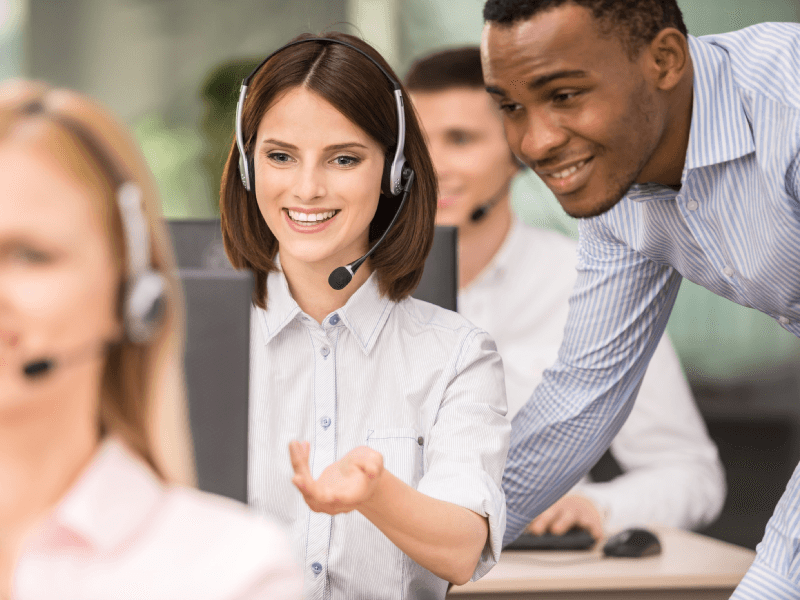 coworkers talking with a phone headset