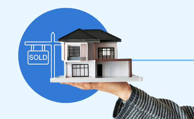 Person holding a house model